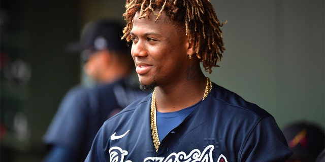 Ronald Acuna Jr. #13 of the Atlanta Braves looks on from the dugout during the fourth inning of a spring training baseball game against the Baltimore Orioles at Ed Smith Stadium on February 26, 2020 in Sarasota, Florida. (Photo by Julio Aguilar/Getty Images)