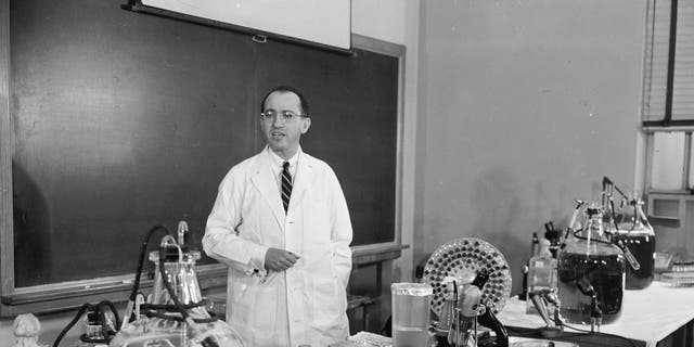 FILE - In this April 8, 1955 file photo, Dr. Jonas Salk, developer of the polio vaccine, describes how the vaccine is made and tested in his laboratory at the University of Pittsburgh. (AP Photo)