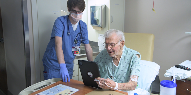 A patient talks with a loved one with an iPad in his hospital room in South Carolina.