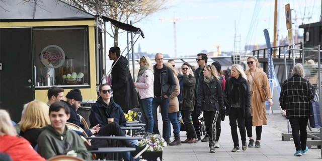 People line up to buy ice cream Sunday in Stockholm, Sweden. (Fredrik SANDBERG / TT News Agency / AFP via Getty Images)