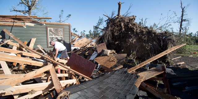 David Maynard sifts through the rubble searching for his wallet, Thursday, April 23, 2020, in Onalaska, Texas, after a tornado destroyed his home the night before.