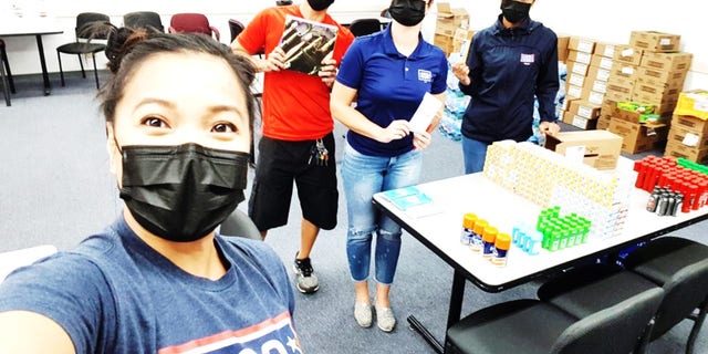 Care packages are broken down by hand, sanitized by a small team working in a warehouse and then re-packed before being delivered to the sailors. (Courtesy of USO)