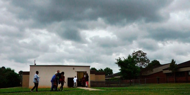 In this April 29, 2014 file image taken from video, people enter a community storm shelter during a tornado watch in Tuscaloosa, Ala.