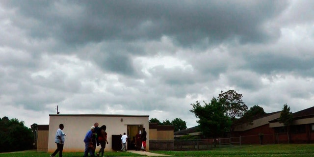 In this April 29, 2014 file image taken from video, people enter a community storm shelter during a tornado watch in Tuscaloosa, Ala.