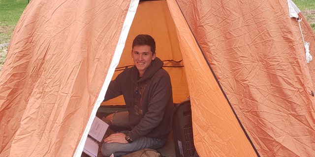Cadet William Taylor, 18, pitched a tent outside his home in rural Pennsylvania to complete his school work from the Virginia Military Institute.
