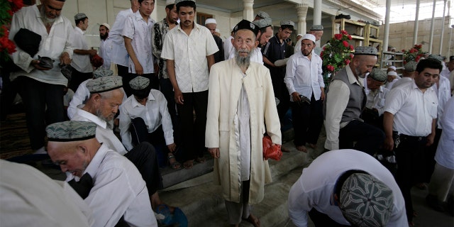 Muslims attend Friday prayers at a mosque in the former Silk Road city of Hotan, Xinjiang province. 