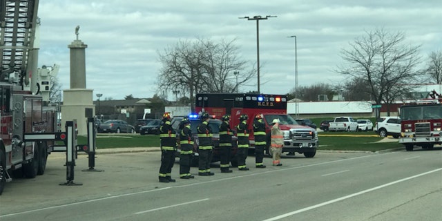 Waukegan firefighters saluted as hearse passed by.