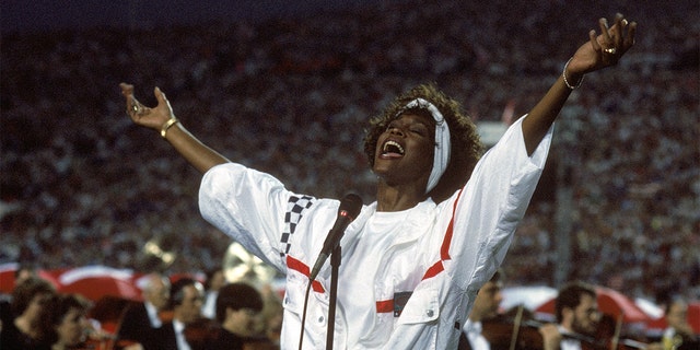 Whitney Houston sings the National Anthem before a game with the New York Giants taking on the Buffalo Bills prior to Super Bowl XXV at Tampa Stadium on January 27, 1991, in Tampa, Fla. 