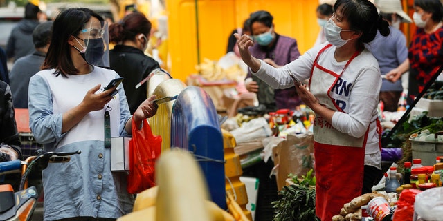 People buy food in Wuhan, capital of central China's Hubei Province, April 16, 2020. As the coronavirus epidemic wanes, life returns to normal in Wuhan gradually. 