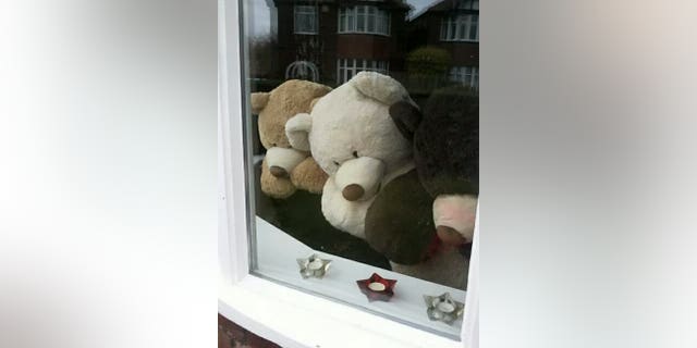 The woman's children have helped her arrange the bears for fun.