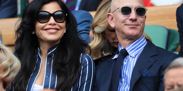 Jeff Bezos and his partner, Lauren Sanchez, look on from the Royal Box on Centre Court on Day 13 of The Championships - Wimbledon 2019 at the All England Lawn Tennis and Croquet Club on July 14, 2019 in London, England. (Photo by Simon Stacpoole/Offside/Getty Images)