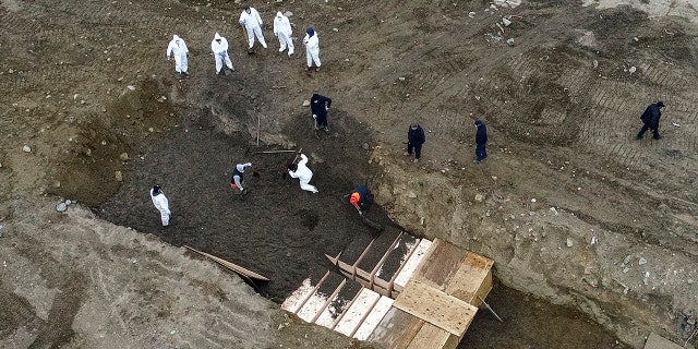 New York City’s medical examiner says the city will hold onto remains for 14 days before they will be transferred to Hart Island. (AP)