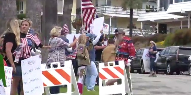 Hundreds gathered Sunday in San Clemente, Calif. gathered to protest California's stay-at-home order meant to slow the spread of coronavirus.