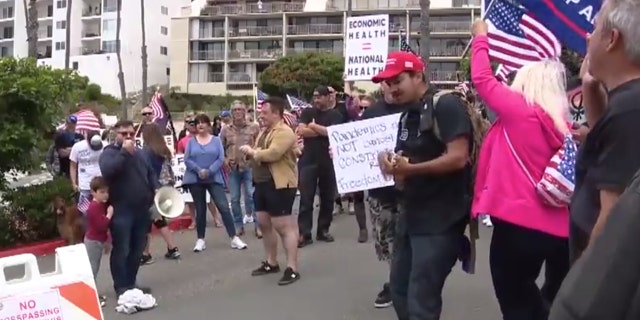 Hundreds gathered Sunday in San Clemente, Calif., gathered to protest California's stay-at-home order meant to slow the spread of coronavirus.