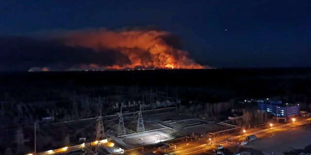 In this photo taken from the roof of Ukraine's Chernobyl nuclear power plant late Friday April 10, 2020, a forest fire is seen burning near the plant inside the exclusion zone.