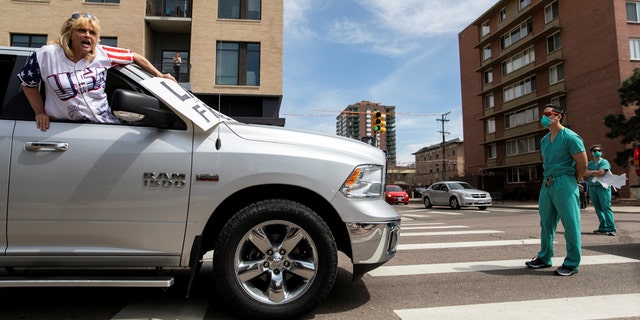 Photos taken Sunday purportedly show health care workers standing in the street in counterprotest of those who gathered at the Colorado State Capitol to demand the end of the state's coronavirus lockdown measures.