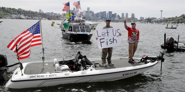 Washington anglers protested by boat on a Seattle lake over the weekend, calling for the state to lift its ban on recreational fishing amid the coronavirus pandemic.(AP Photo/Ted S. Warren)