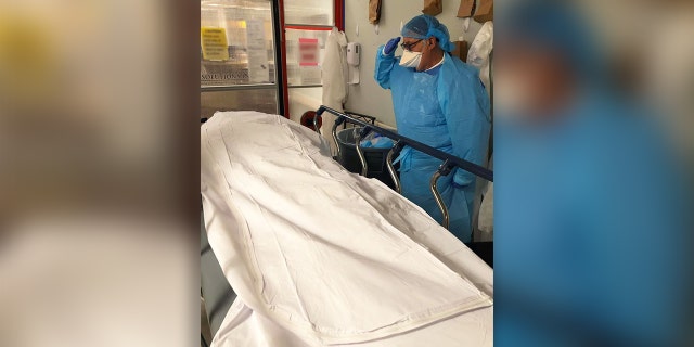 Marc Kagan, an Air Force veteran and nurse at Manatee Memorial Hospital in Bradenton, Fla., salutes a veteran who died from the coronavirus.