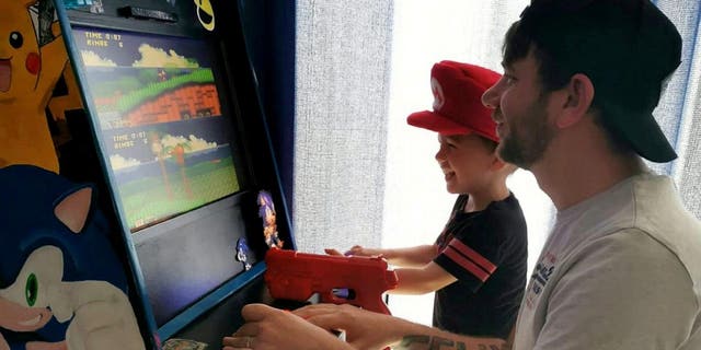 Steve Addison, who works as an assistant manager at McDonalds, found himself at a loose end after being put on furlough leave. But rather than stew around the house all day, the 32-year-old decided to finish off a plan to dig out an Atari he got as a Christmas gift and create a cabinet so he and three-year-old son Felix could play on it. (Credit: SWNS)