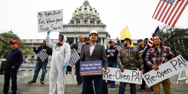 Protesters demonstrate at the state Capitol in Harrisburg, Pa., Monday, April 20, 2020.. (AP Photo/Matt Rourke)