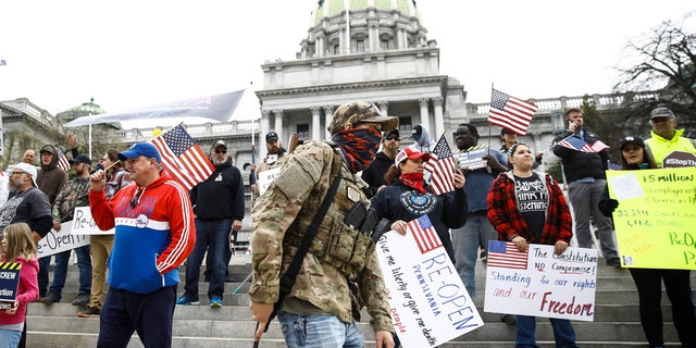 Protesters demonstrate at the state Capitol in Harrisburg, Pa., Monday, April 20, 2020, demanding that Gov. Tom Wolf reopen Pennsylvania's economy even as new social-distancing mandates took effect at stores and other commercial buildings. (AP Photo/Matt Rourke)