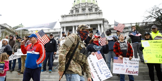 Protesters demonstrate at the state Capitol in Harrisburg, Pa., Monday, April 20, 2020, demanding that Gov. Tom Wolf reopen Pennsylvania's economy even as new social-distancing mandates took effect at stores and other commercial buildings. (AP Photo/Matt Rourke)