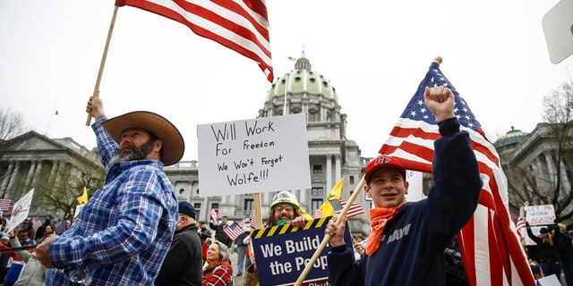 Protesters demonstrate at the state Capitol in Harrisburg, Pa., Monday, April 20, 2020, demanding that Gov. Tom Wolf reopen Pennsylvania's economy even as new social-distancing mandates took effect at stores and other commercial buildings. (AP Photo/Matt Rourke)