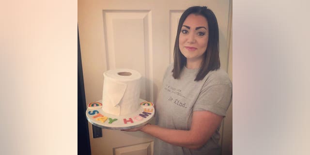 Lisa Jamieson, 38, baked the chocolate fudge sponge cake on Tuesday evening, iced to look like a toilet roll, and emblazoned with icing letters spelling out “STAY HOME.”