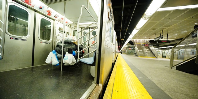 A homeless person takes shelter in a subway train AT Hudson Yards, New York City during a rainy afternoon amid COVID-19 pandemic on April 3, 2020. (Photo by John Nacion/NurPhoto via Getty Images)