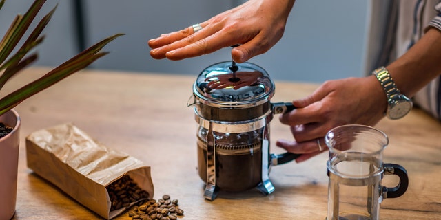 French press coffee makers brew or steep coffee grounds as the pot's plunger attachment lowers over time.