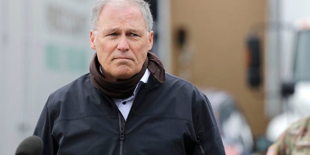 Gov. Jay Inslee addresses reporters in Lakewood, Wash., April 3, 2020. (Associated Press)