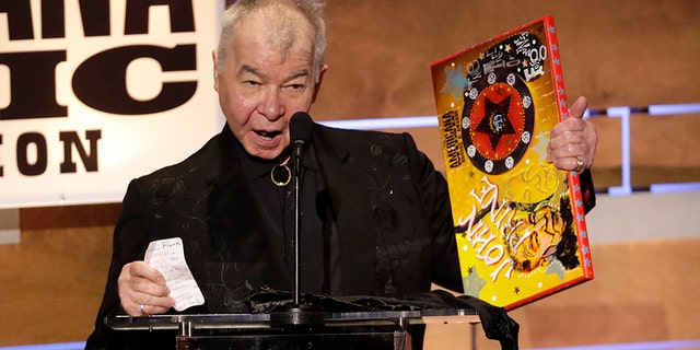 FILE - In this Sept. 11, 2019 file photo, John Prine accepts the Album of the Year award at the Americana Honors &amp; Awards show in Nashville, Tenn. 