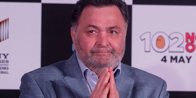 In this April 19, 2018 file photo, Bollywood actor Rishi Kapoor greets media as he arrives for the song launch of film '102 Not Out' in Mumbai, India. 
