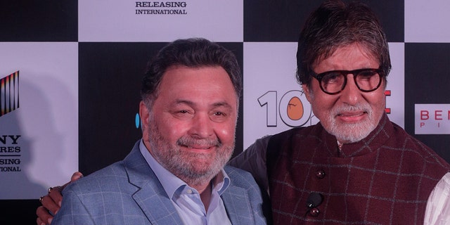 Bollywood actor Rishi Kapoor, left poses with actor Amitabh Bachchan the song launch of film '102 Not Out' in Mumbai, India. 