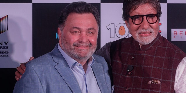 Bollywood actor Rishi Kapoor, left poses with actor Amitabh Bachchan the song launch of film '102 Not Out' in Mumbai, India.