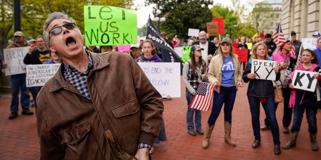 A protestor shouts as hundreds outside of the Kentucky State Capitol to rally against current social distancing requirements and business closures ordered by Gov. Andy Beshear, amid the outbreak of the coronavirus disease (COVID-19), in Frankfort, Kentucky, U.S. April 15, 2020. REUTERS/Bryan Woolston - RC2A5G9XRW3P