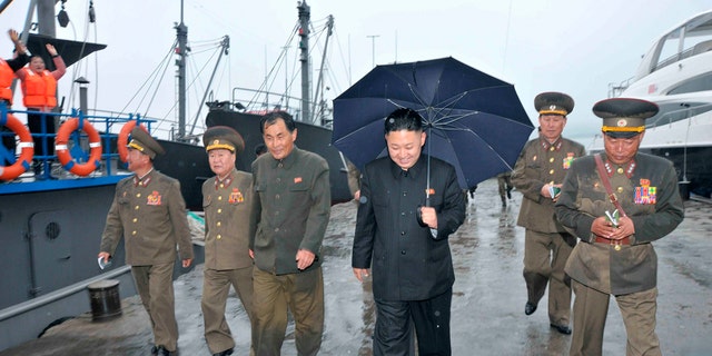 Kim Jong-un is seen inspecting the fishery station at Wonsan on North Korea's east coast in thie 2013 photo, with a luxury yacht seen in the background.