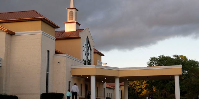 Congregants arrive for an evening service at the Life Tabernacle Church in Central, La., on March 31. Pastor Tony Spell says he will keep violating a ban on gatherings put in place to control the spread of the coronavirus because God told him to. (AP Photo/Gerald Herbert)