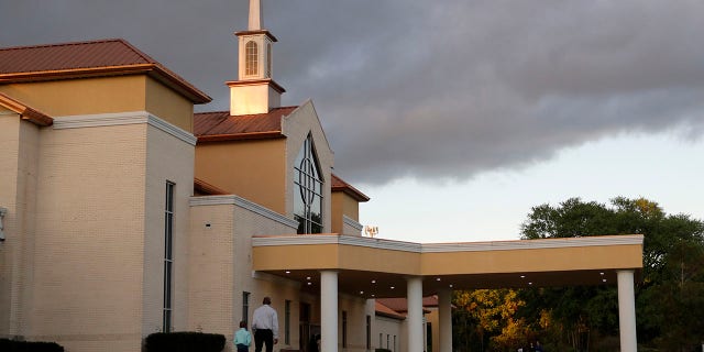 Congregants arrive for an evening service at the Life Tabernacle Church in Central, La., on March 31. Pastor Tony Spell says he will keep violating a ban on gatherings put in place to control the spread of the coronavirus because God told him to. (AP Photo/Gerald Herbert)