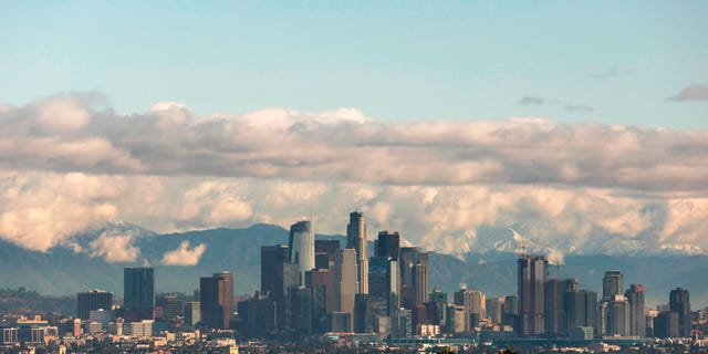 A view of the downtown Los Angeles skyline with the snow-covered San Gabriel Mountains in the background on November 29, 2019 in Los Angeles, California. (Photo by APU GOMES/AFP via Getty Images)