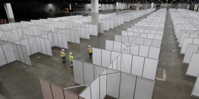 In this April 1, 2020, photo the interior of the TCF Center with temporary hospital rooms is seen inside the convention center in Detroit.