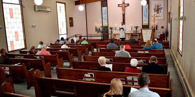 Members of Christ the King Lutheran Church in Billings, Montana sing a hymn during a service Sunday following a phase-in reopening of businesses and gathering places as infection rates from the coronavirus decline in the state. (AP Photo/Matthew Brown)