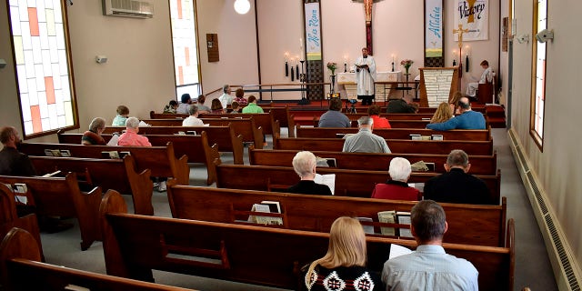 Members of Christ the King Lutheran Church in Billings, Montana sing a hymn during a service Sunday following a phase-in reopening of businesses and gathering places as infection rates from the coronavirus decline in the state. (AP Photo/Matthew Brown)