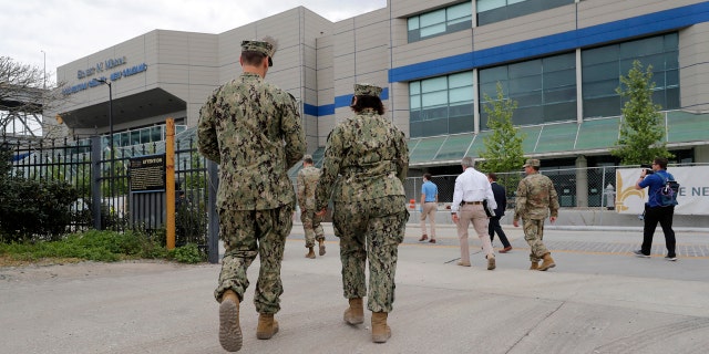 National Guard personnel walking outside the Ernest N. Morial Convention Center in New Orleans, after officials set up a temporary hospital there amid the coronavirus.