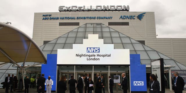 NHS staff gather during the opening of the Nightingale Hospital at the ExCel center in London on Friday. (AP)