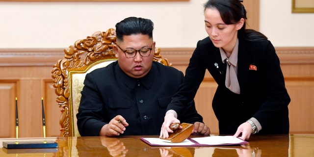 In this September 19, 2018 file photo, Kim Yo Jong, right, sister of North Korean leader Kim Jong Un, helps Kim sign a joint statement after the summit with South Korean President Moon Jae-in at the Paekhwawon State Guesthouse in Pyongyang .