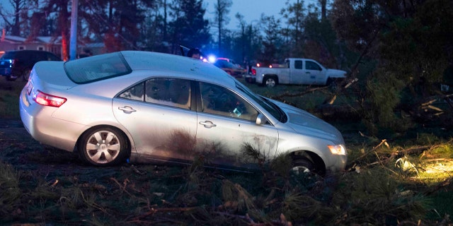 A car is seen in a ditch in Onalaska, Texas, after a tornado touched down in the area Wednesday, April 22, 2020.