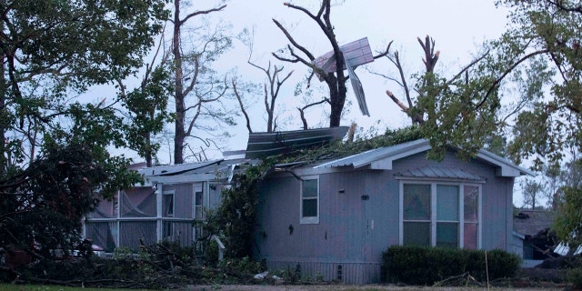 A damaged home is seen after an apparent tornado touched down Wednesday, April 22, 2020, in Onalaska, Texas.