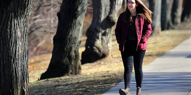 Alexis Rickmers walks around Chandler Pond and Gallagher Park in Boston on March 18, 2020. She is among many people suffering from anxiety, paranoia, and hypochondria amid the coronavirus. She says daily walks help. (Photo by Lane Turner/The Boston Globe via Getty Images)