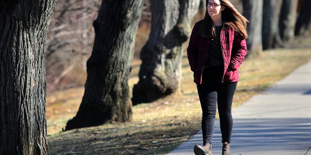 Alexis Rickmers walks around Chandler Pond and Gallagher Park in Boston on March 18, 2020. She is among many people suffering from anxiety, paranoia, and hypochondria amid the coronavirus. She says daily walks help. (Photo by Lane Turner/The Boston Globe via Getty Images)